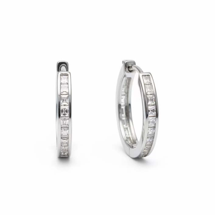 Hand holding two diamond rings with a dark background