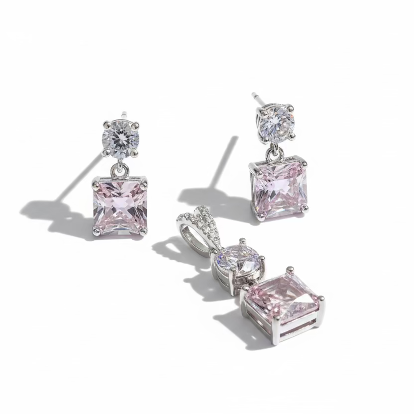 Pair of pink gemstone earrings on a white background