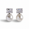 Pair of earrings with pearl and crystal elements on a white background
