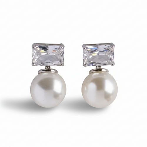 Pair of earrings with pearl and crystal elements on a white background