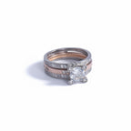 Silver ring with a diamond on a light gray background