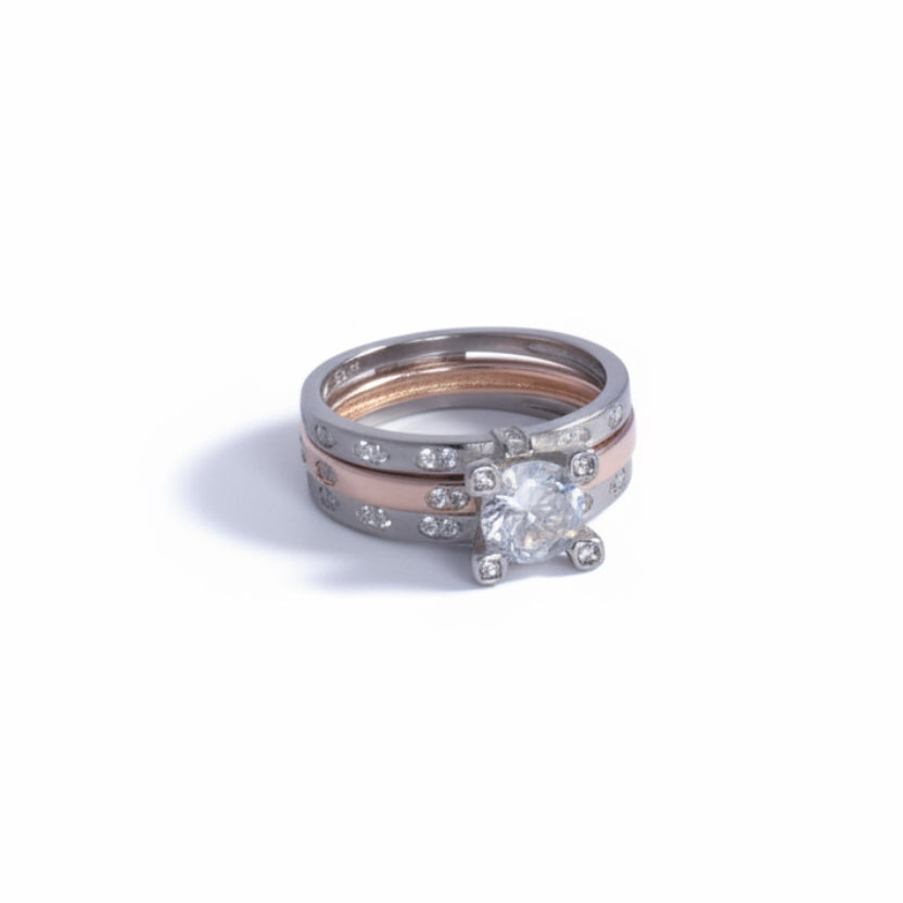 Silver ring with a diamond on a light gray background