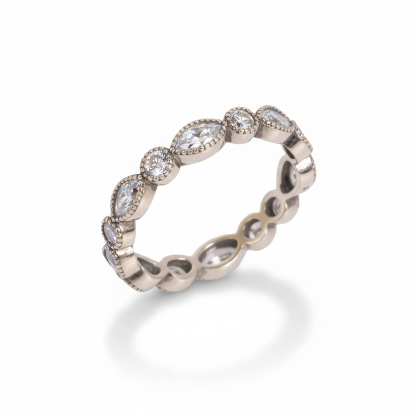 Silver ring with embedded stones on a white background