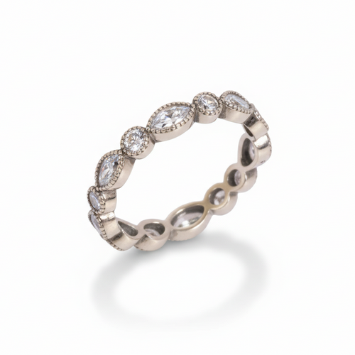 Silver ring with embedded stones on a white background