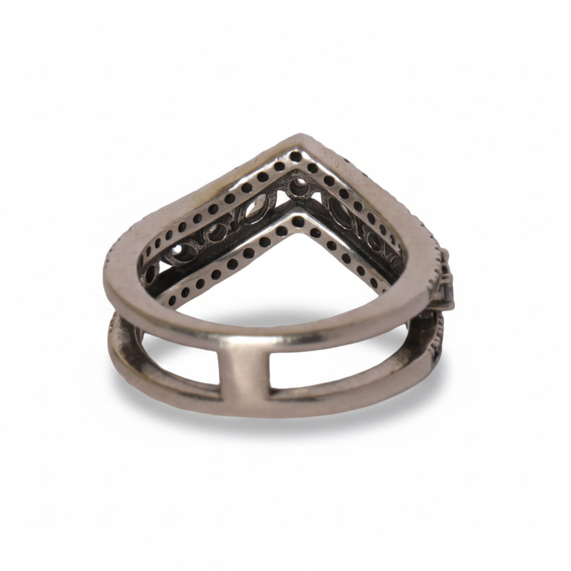 Silver ring with geometric design on a gray background