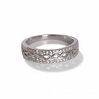 Silver ring with diamond-like stones on a light gray background