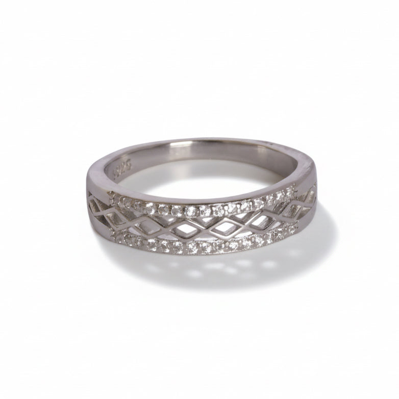 Silver ring with diamond-like stones on a light gray background