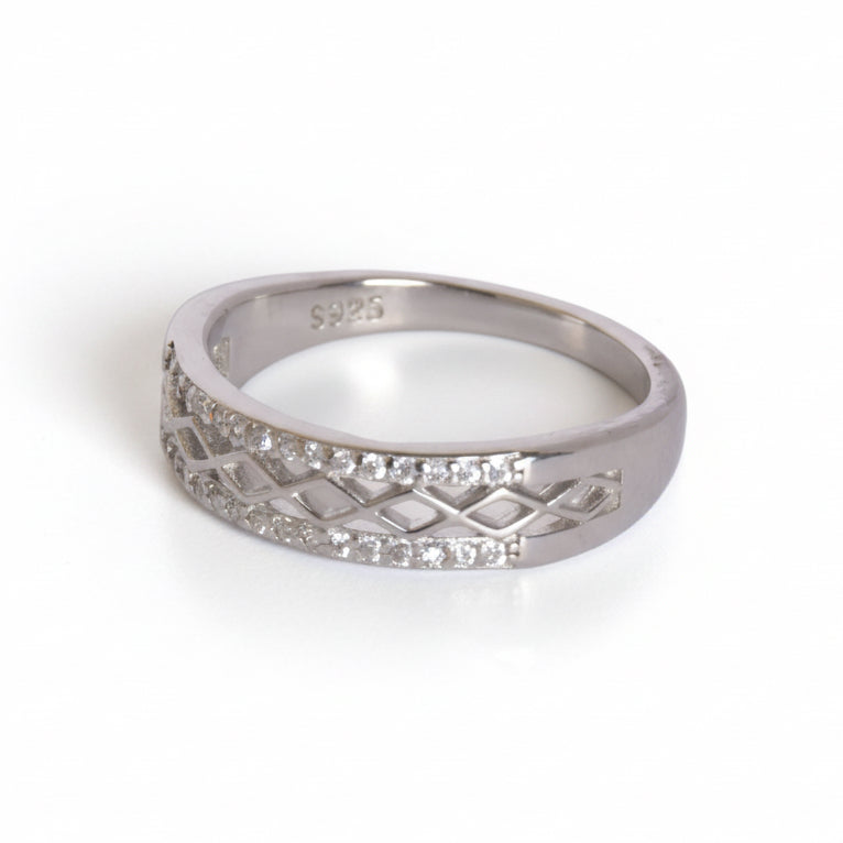 Silver ring with diamond accents on a white background