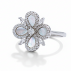 Silver ring with opal stones and diamonds on a light gray background