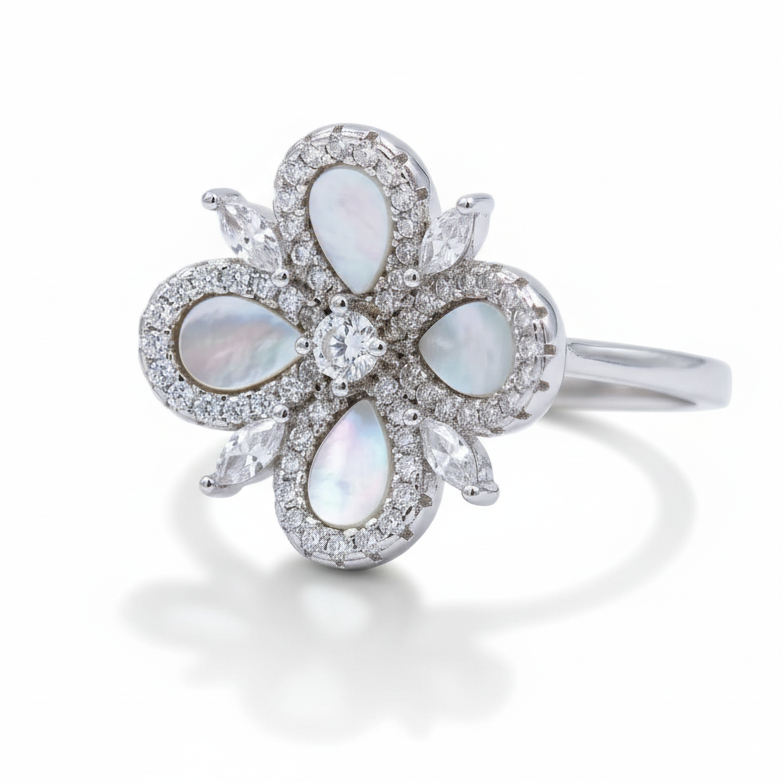 Silver ring with opal stones and diamonds on a light gray background