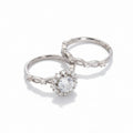 Two silver rings with gemstones on a light gray background