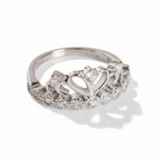 Silver ring with diamond accents on a white background