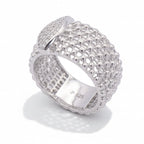 Silver ring with intricate design on a light gray background