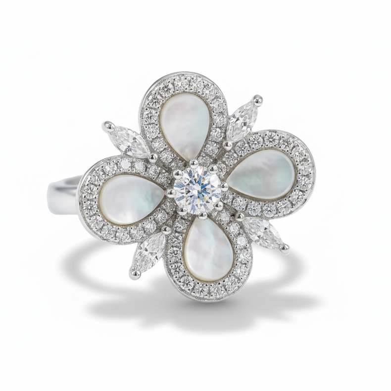 Elegant ring with floral design featuring pearls and a diamond on a light gray background