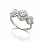 Diamond ring held by a hand against a brown background