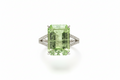 Ring with a green gemstone on a white background