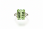 Ring with a green gemstone on a white background