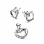 Silver heart-shaped earrings and pendant on a white background