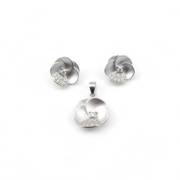 Silver jewelry set with pendant and earrings on a white background