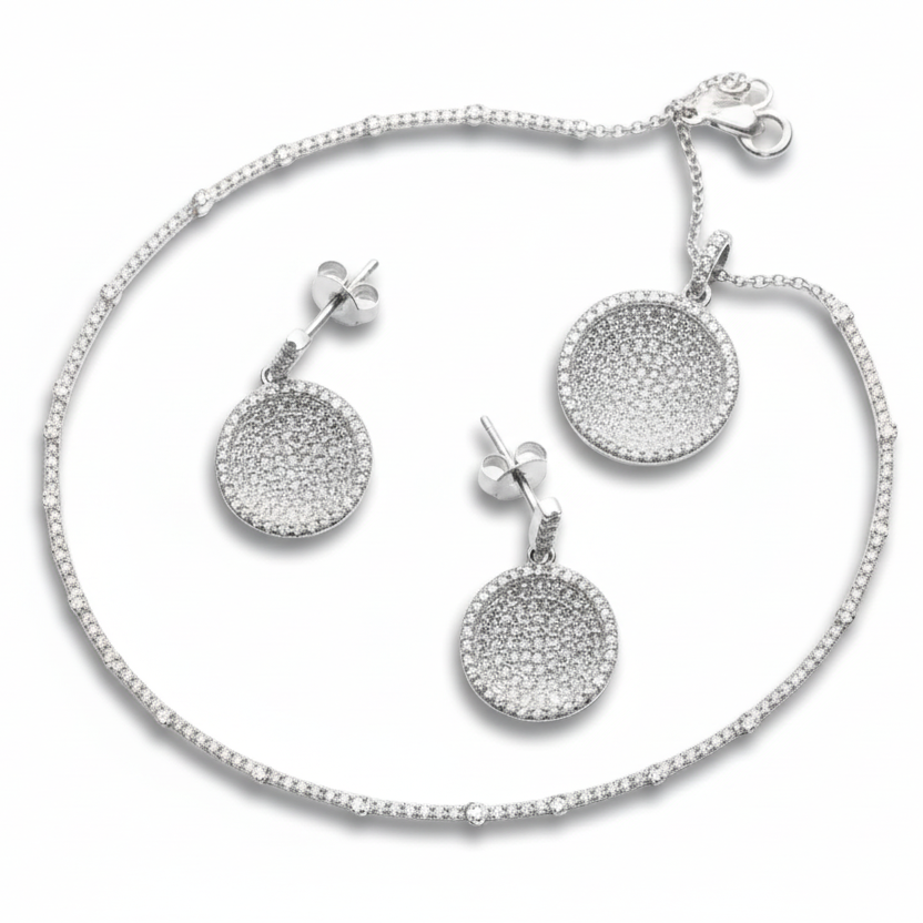 Silver jewelry set with round pave-disc earrings and a matching bracelet on a white background