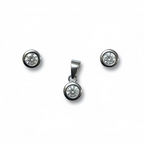 Silver jewelry set with round gemstones on a white background