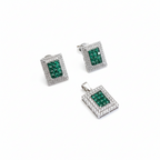Set of silver jewelry with green gemstones on a white background