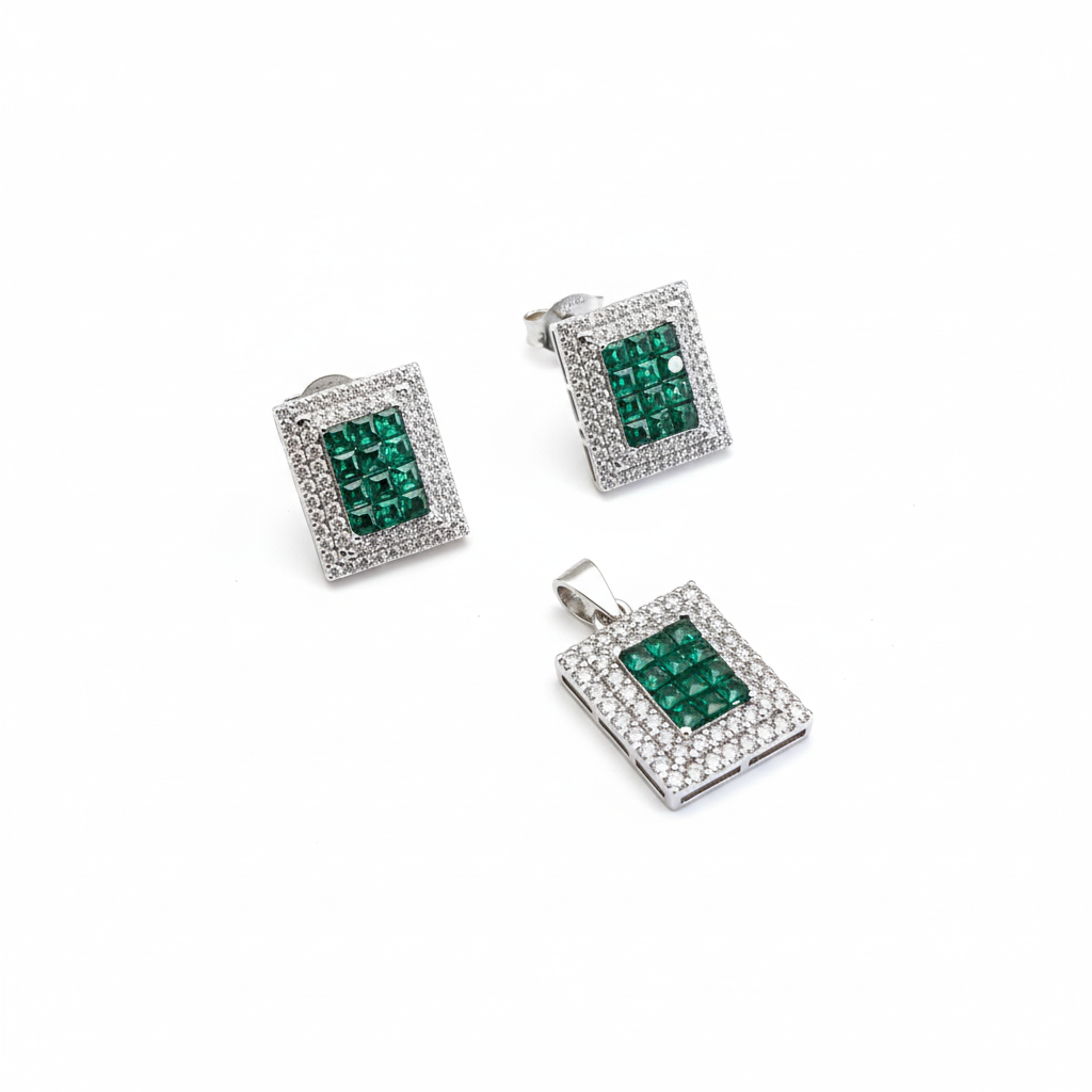 Set of silver jewelry with green gemstones on a white background