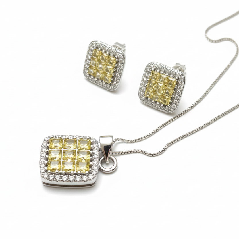 Jewelry set with yellow gemstones and silver accents on a white background