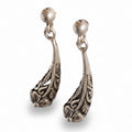 Pair of silver earrings with intricate designs on a white background