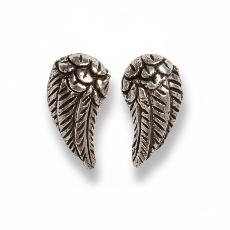 Pair of silver angel wing earrings on a white background