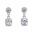 Pair of silver earrings with clear gemstones on a light gray background