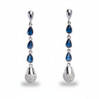Pair of silver earrings with blue gemstones on a white background