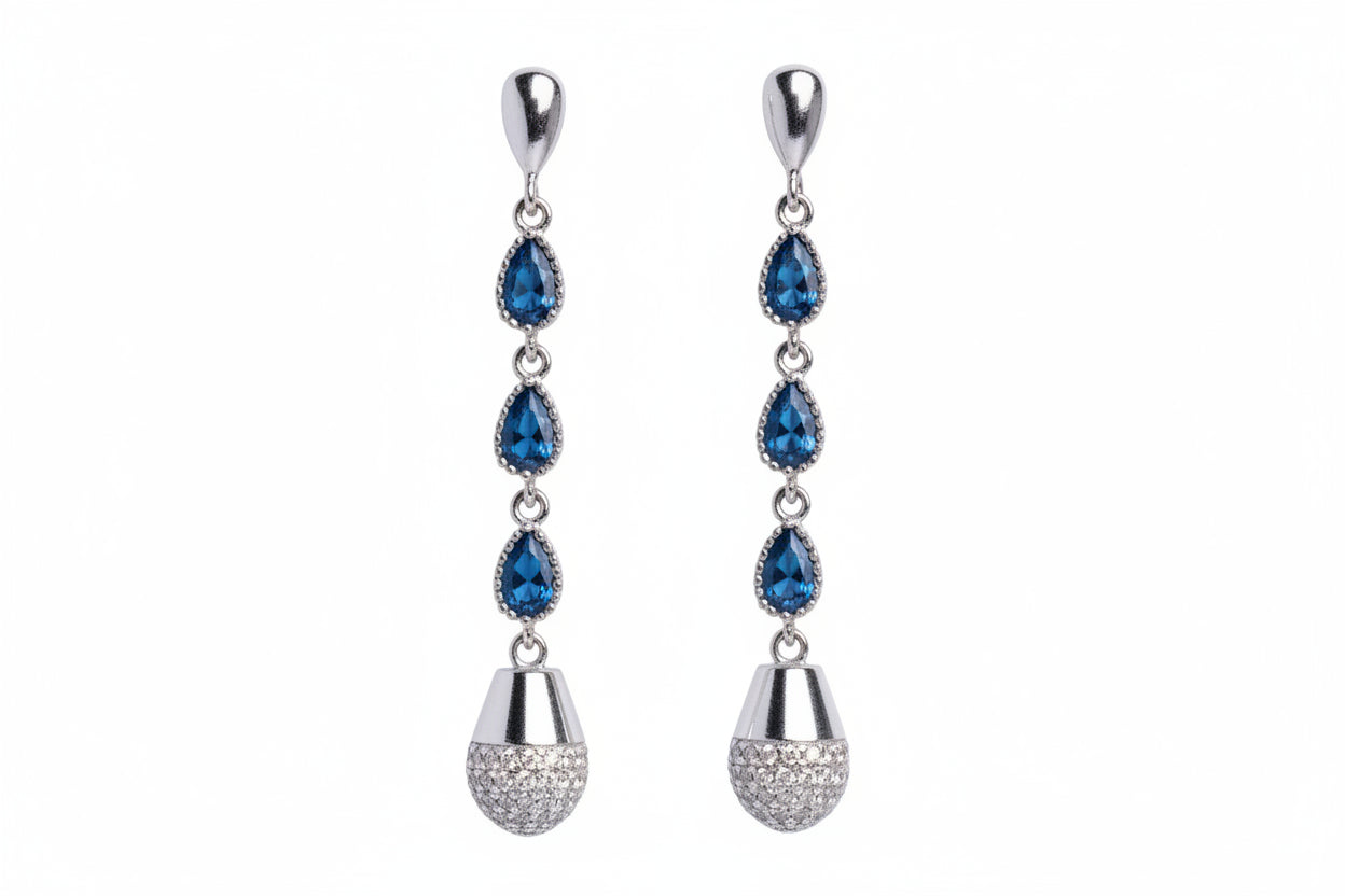 Pair of silver earrings with blue gemstones on a white background