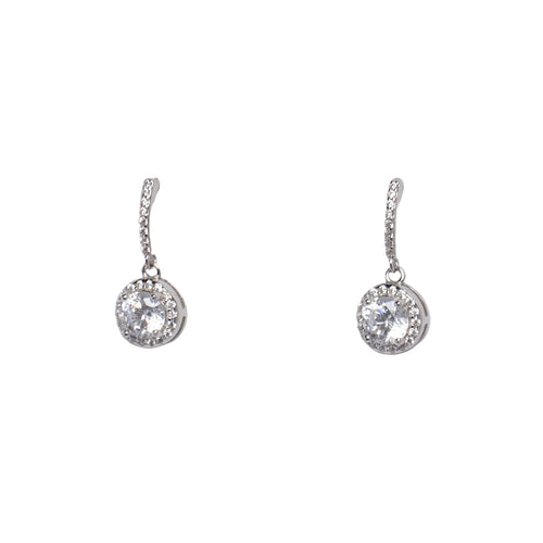 Pair of silver earrings with clear gemstones on a light gray background