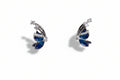 Butterfly-shaped earrings with blue centers and silver accents on a light gray background