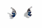 Butterfly-shaped earrings with blue centers and silver accents on a light gray background