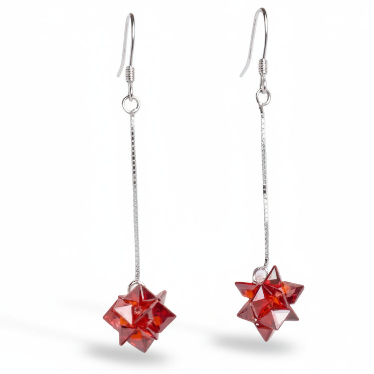 Red geometric earrings on a white background