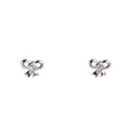 Pair of silver bow-shaped earrings with a central gemstone on a light gray background