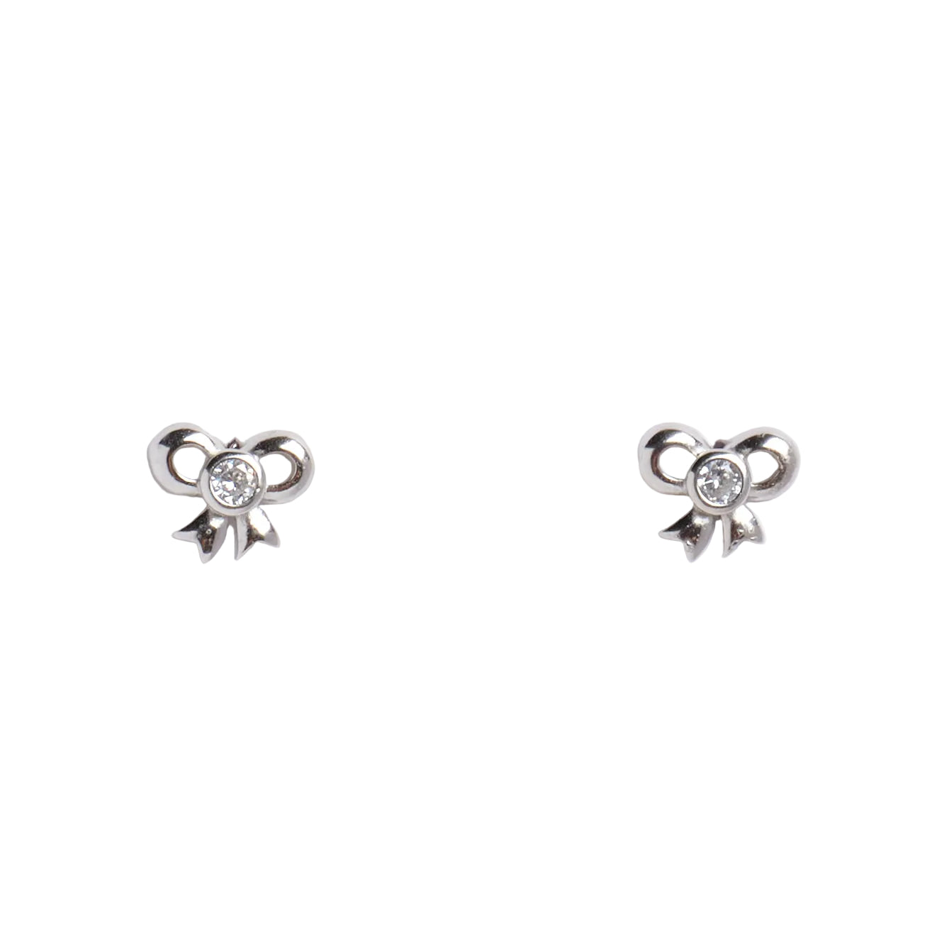 Pair of silver bow-shaped earrings with a central gemstone on a light gray background