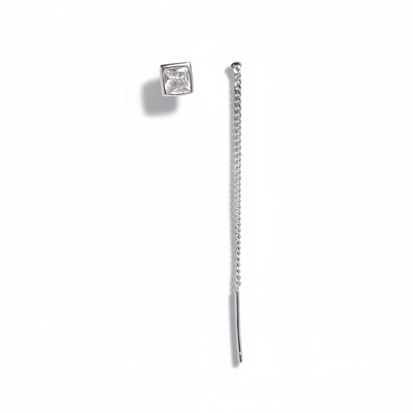 Silver earring with a chain on a white background