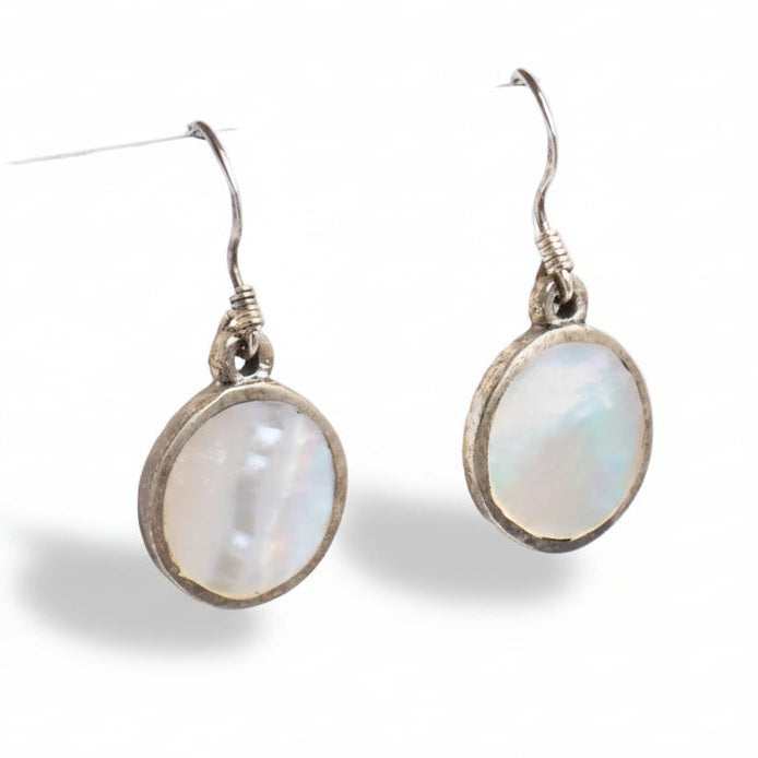 Pair of earrings with round, light-colored gemstones on a white background