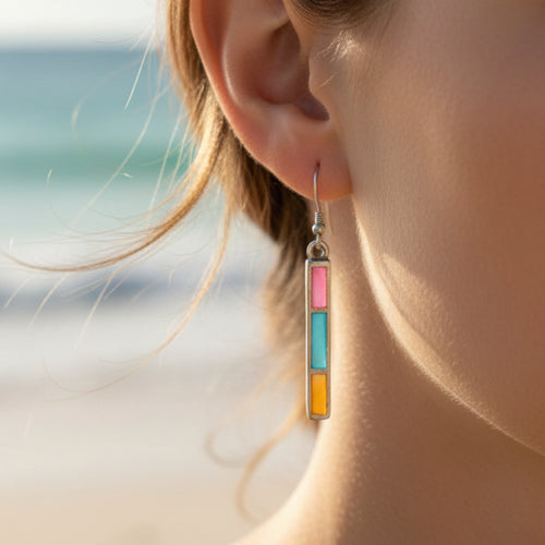 Pair of earrings with colorful rectangular stones on a white background
