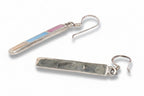 Pair of earrings with rectangular silver pendants on a white background