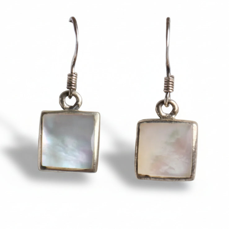 Pair of square-shaped earrings with silver hooks on a white background