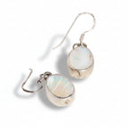 Pair of silver earrings with opal stones on a white background