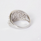 Silver ring with intricate design on a white background