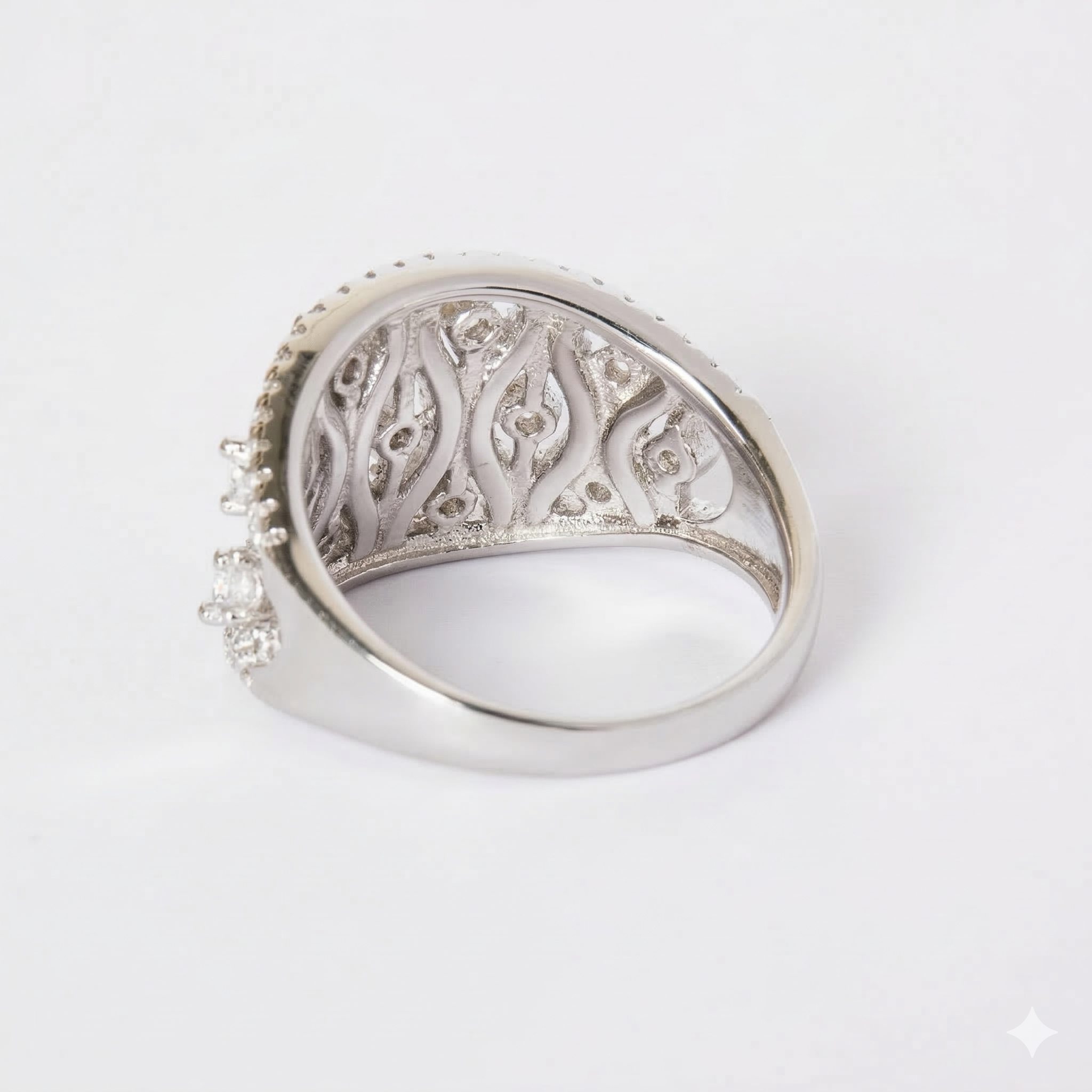 Silver ring with intricate design on a white background