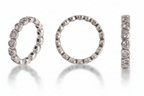 Three silver rings with diamond accents on a light gray background