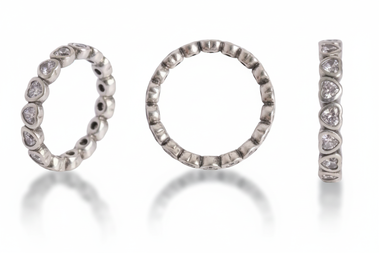 Three silver rings with diamond accents on a light gray background