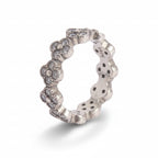 Silver ring with floral designs on a light gray background